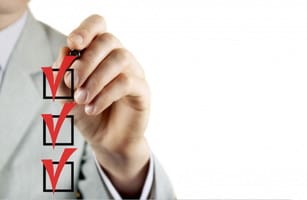 フランスでは、ビジネスマンがマーカーを持ち、チェックリストにチェックマークを描いています。 shutterstock_125522081